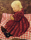 Ребёнок на подушке в красную клетку